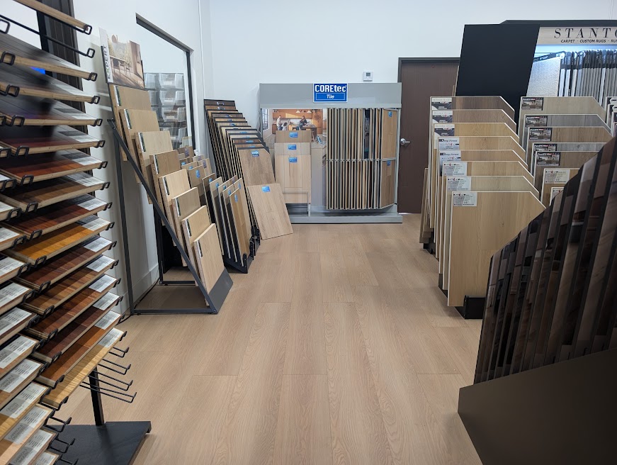 A bright aisle of flooring displays in the CQ Floors Suite C showroom